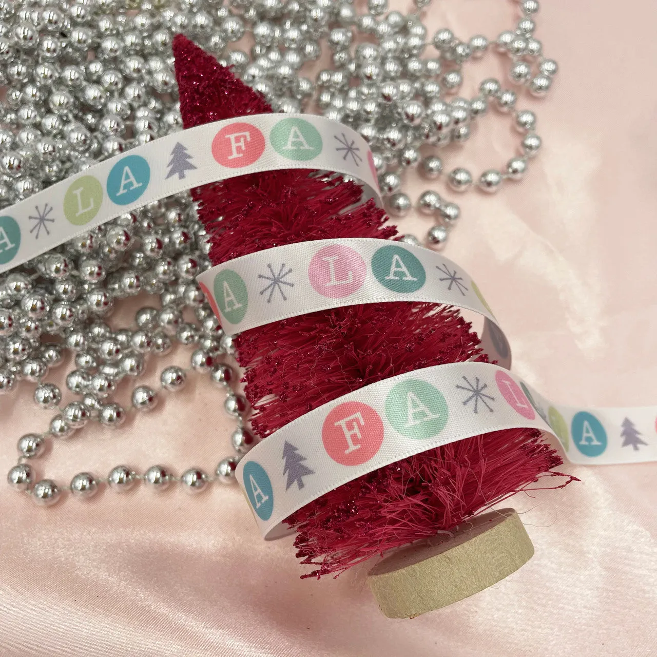 Christmas Ribbon Fa La La in pastels printed on 5/8" white single face satin